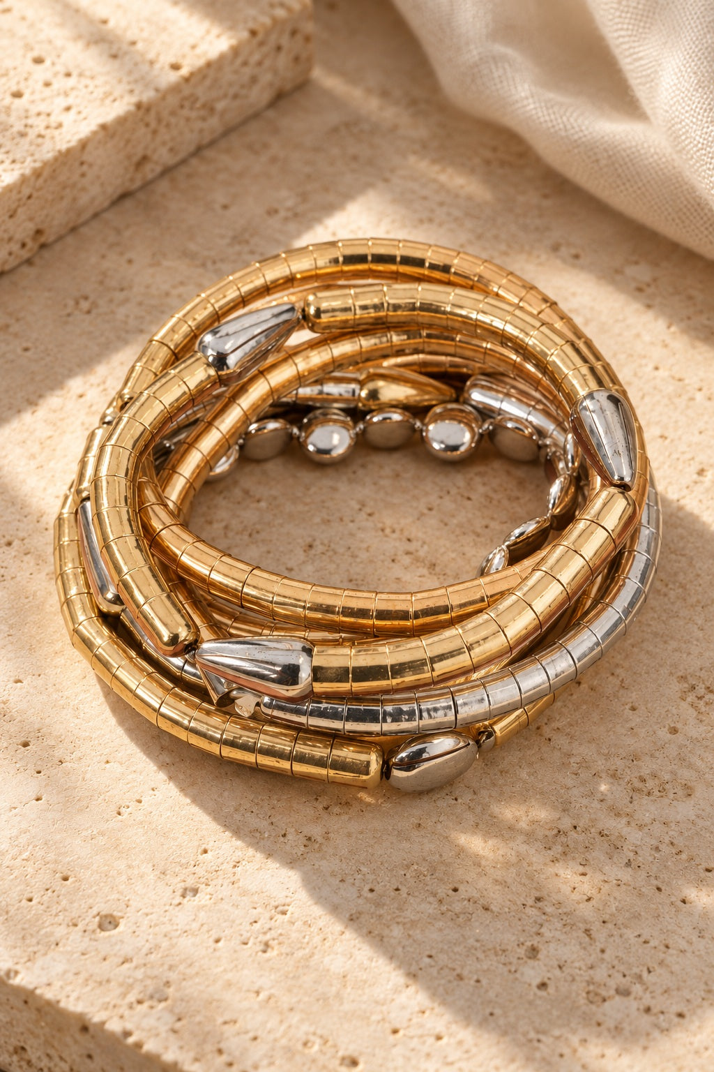 Gold Rush Twist Coil Bangles on stone
