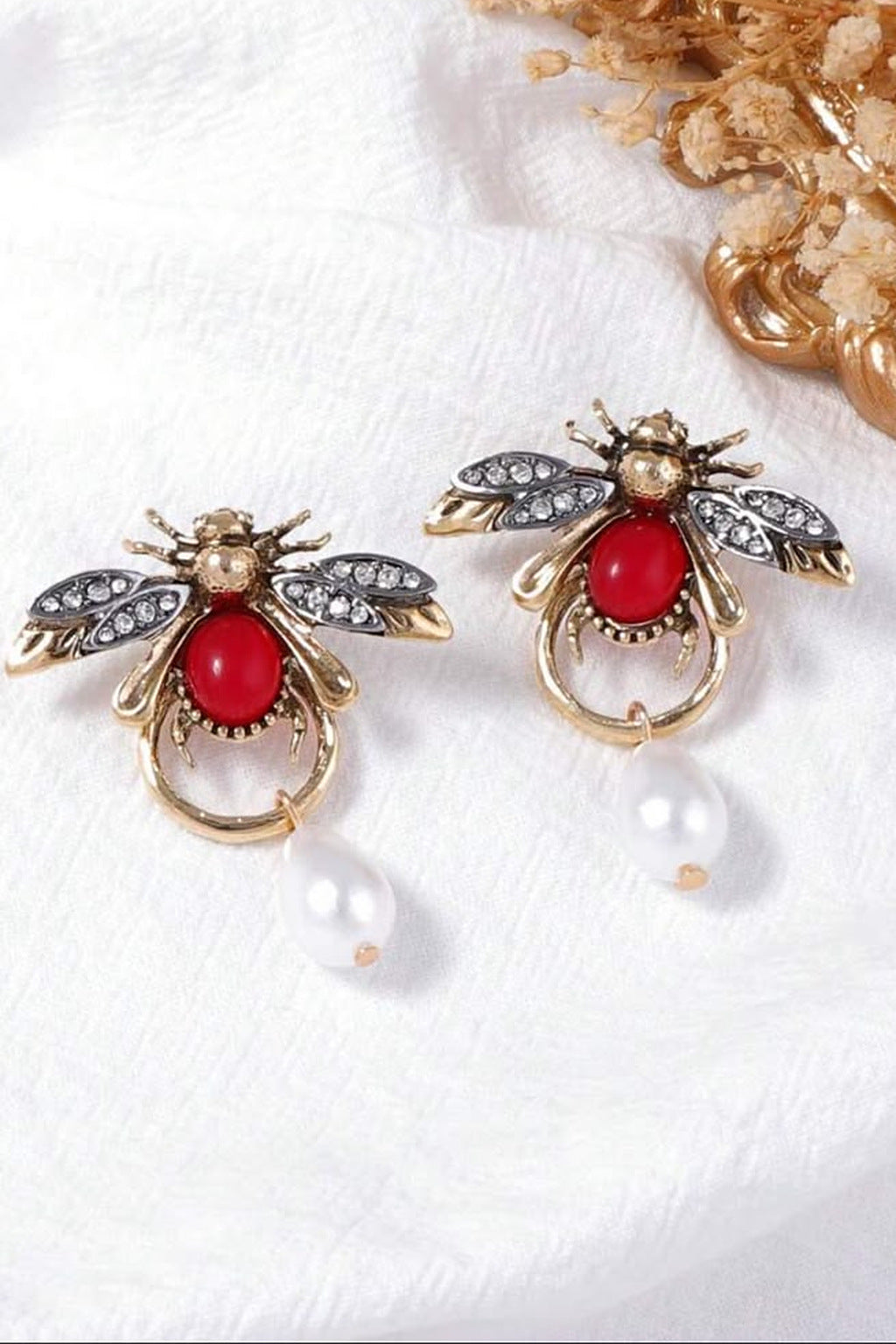 Ruby Bee Pearl Drop Earrings pair on linen