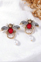 Ruby Bee Pearl Drop Earrings pair on linen
