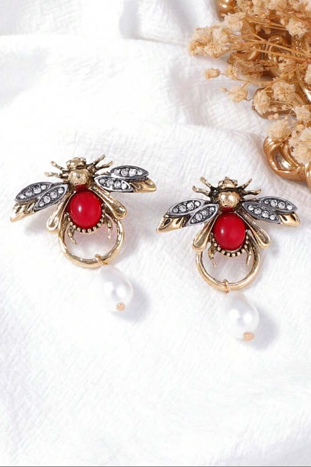 Ruby Bee Pearl Drop Earrings pair flat lay