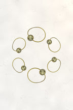 Bubble Ponytail Set of 6 – 6 gold ball hair ties arranged in a circle on marble