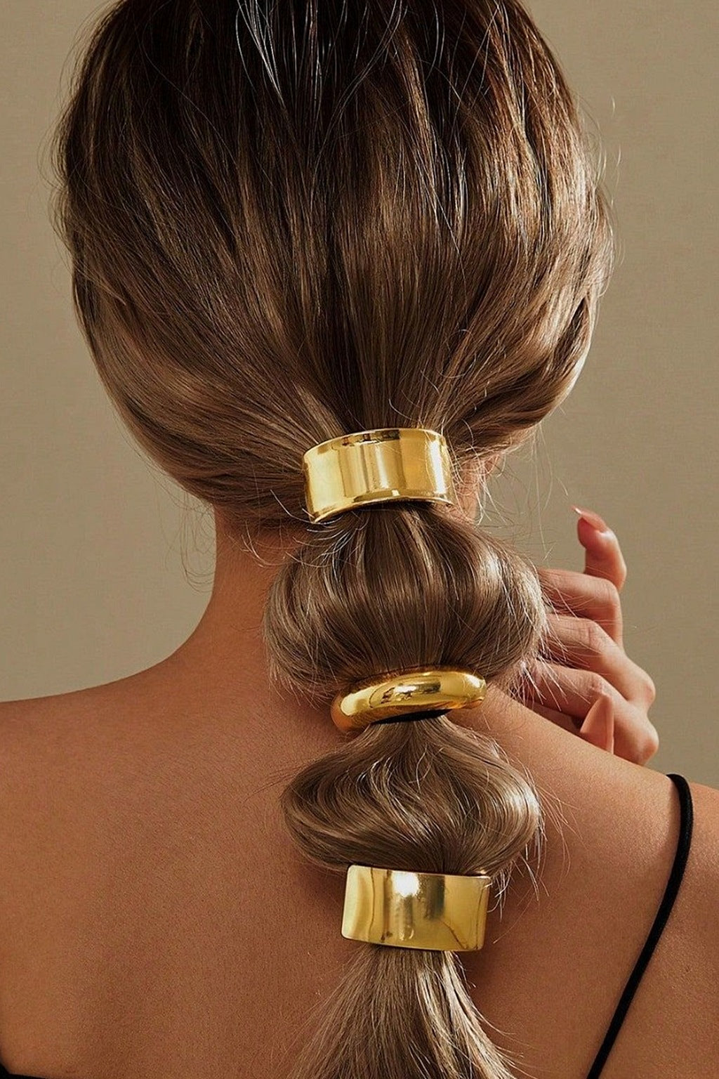 Gold ponytail cuffs worn on a bubble ponytail