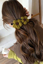 Crochet Flower Claw Clip - Olive worn on a half-up style