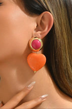 Heart Throb Drop Earrings worn on the ear