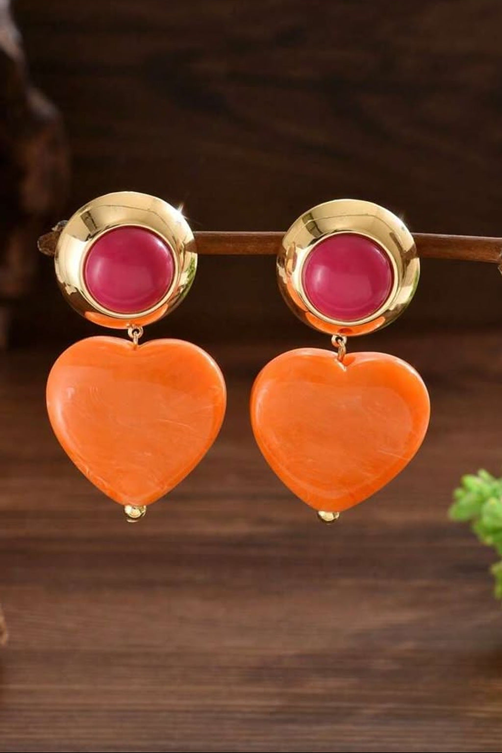 Heart Throb Drop Earrings orange heart earrings on wood