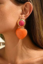 Heart Throb Drop Earrings worn on the ear, close-up