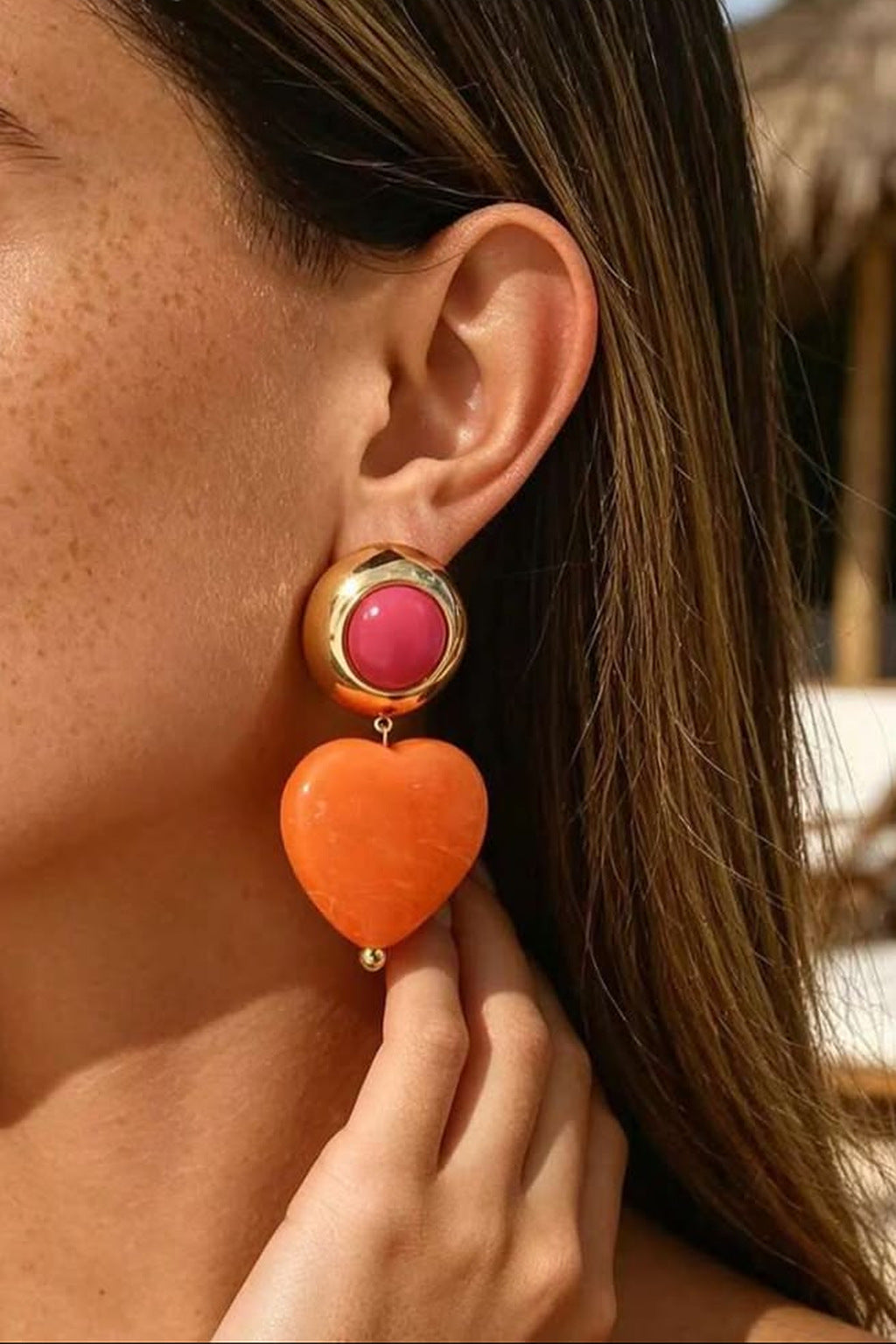 Heart Throb Drop Earrings worn with hand at the drop