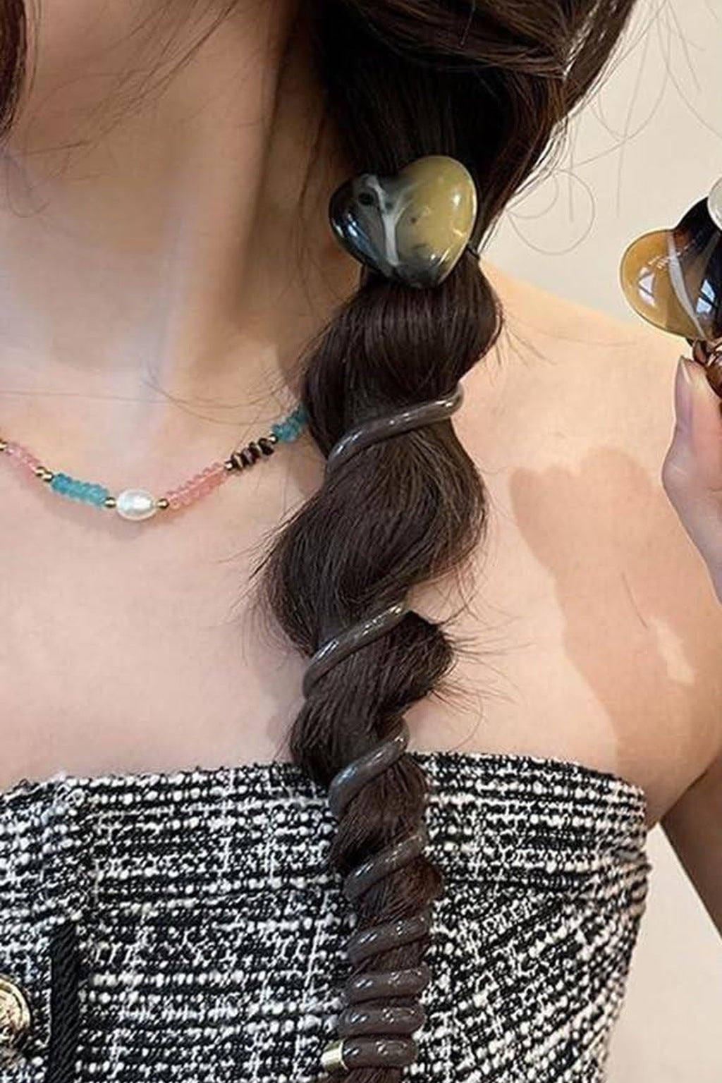 Heart spiral hair tie worn on a braid