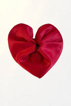 Big Heart Scrunchie – red satin heart scrunchie on white in soft sunlight