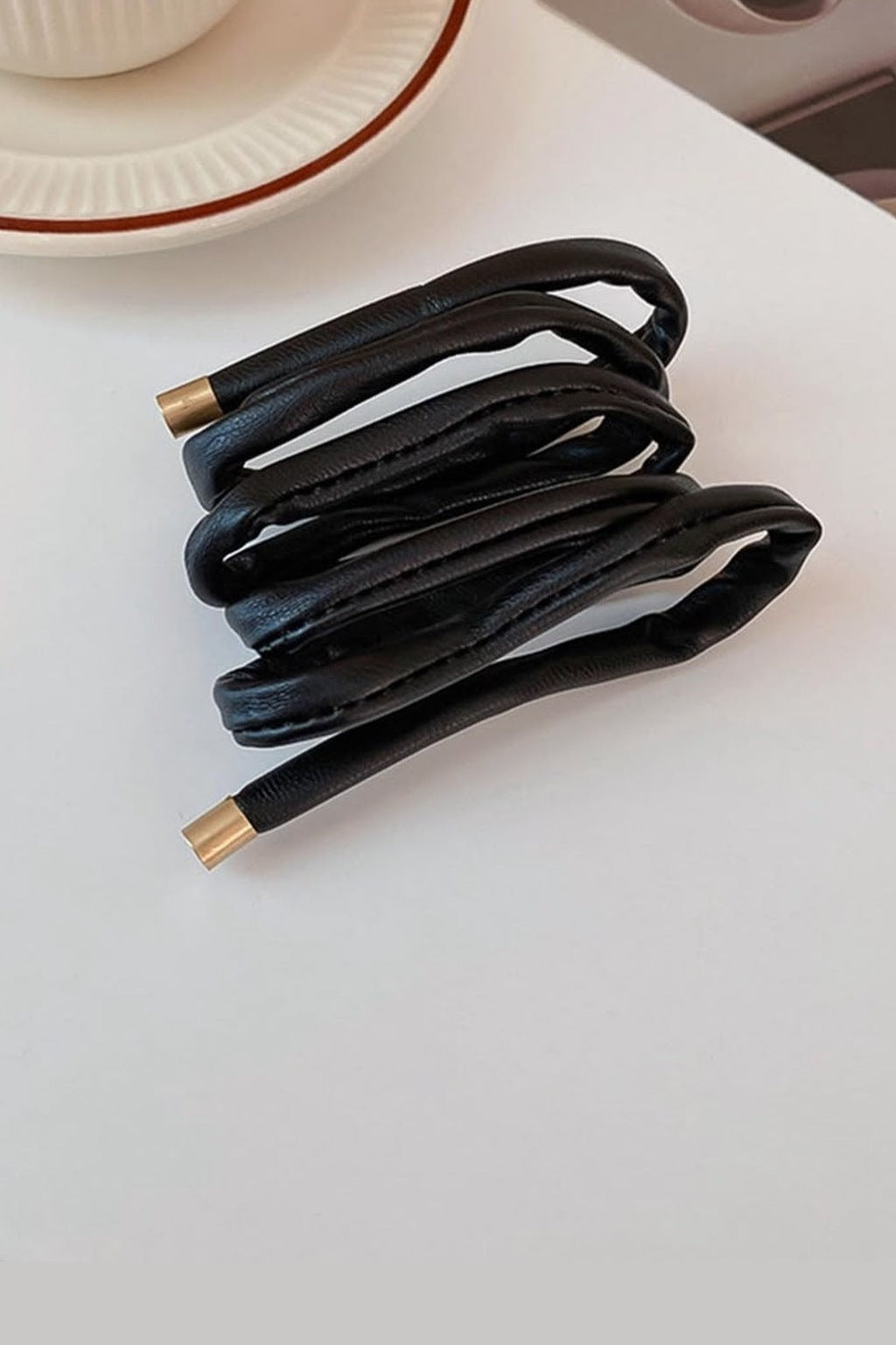 Leather Wrap Ponytail Tie - Black wrap detail with gold tips