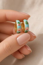 Lotus Lagoon Huggie Earrings – turquoise enamel lotus huggies held in hand