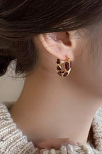 Burgundy Swirl Hoop Earrings worn on the ear