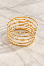 Golden Halo Wire Bangle Stack on marble