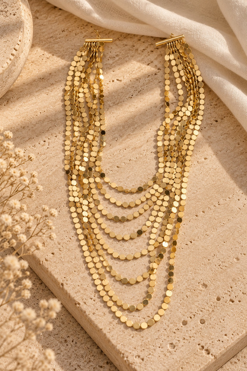 Golden Shimmer Layered Coin Necklace on stone