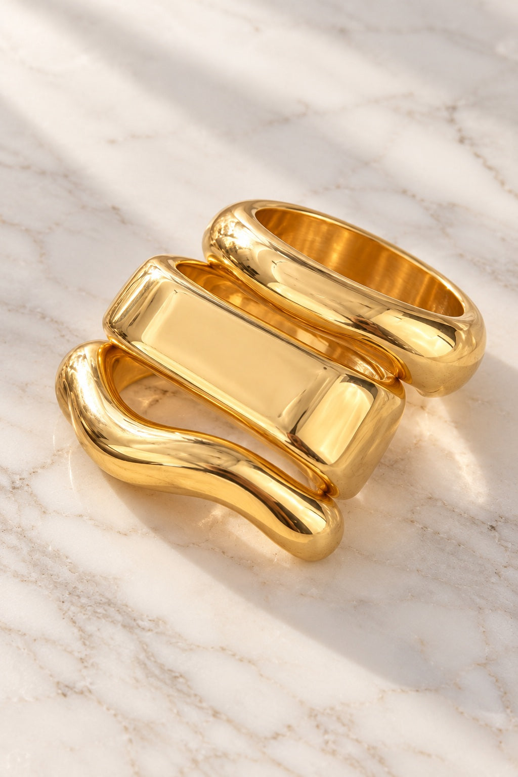 Liquid Gold Sculpt Bangles on marble