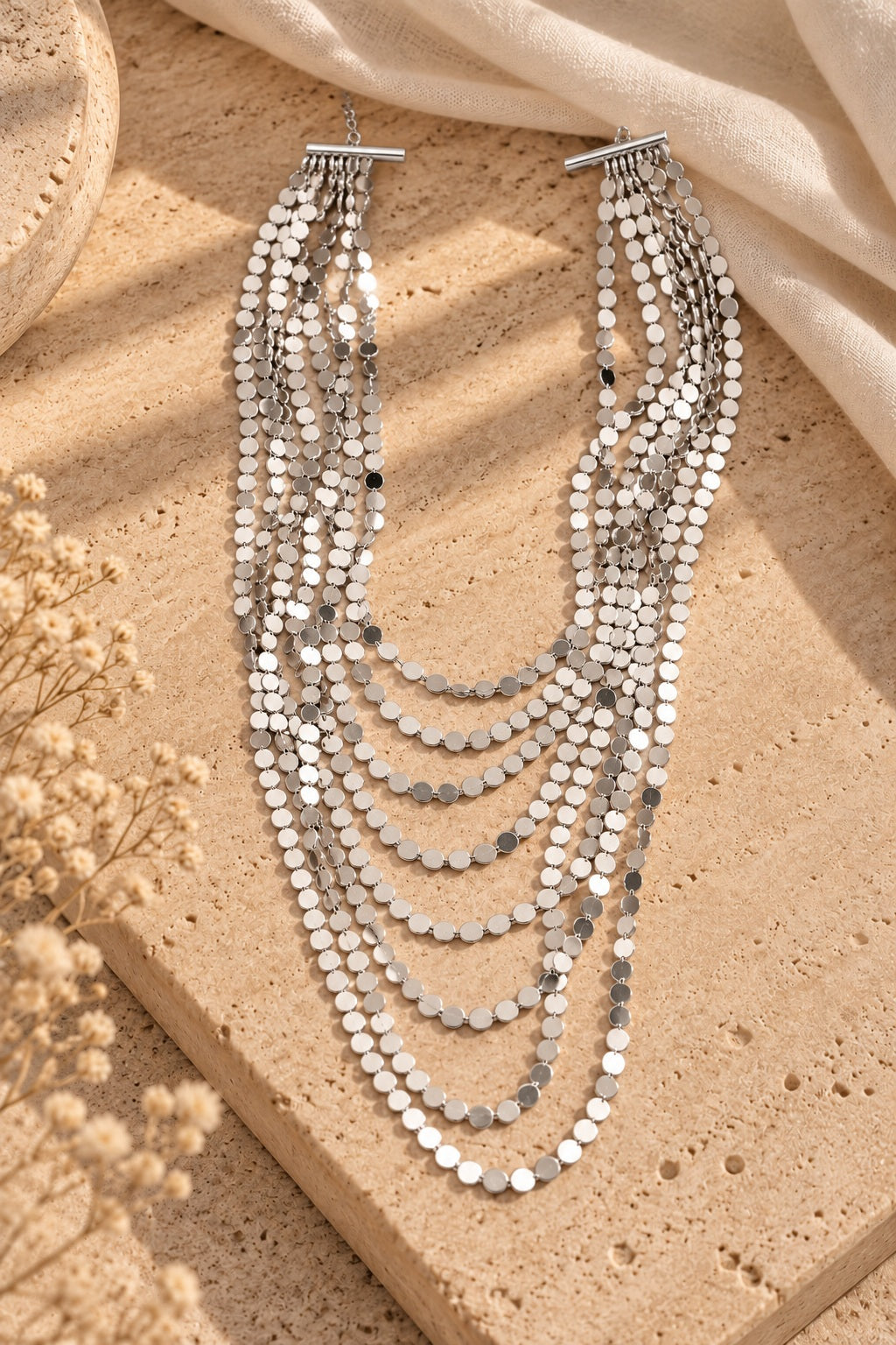 Silver Shimmer Layered Sequin Necklace on stone