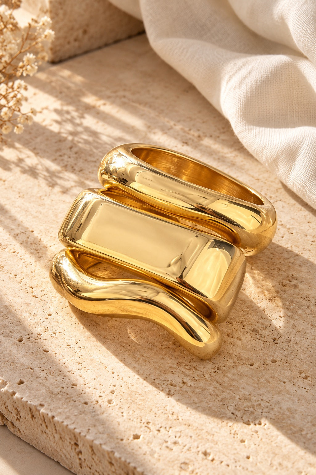 Liquid Gold Sculpt Bangles on stone