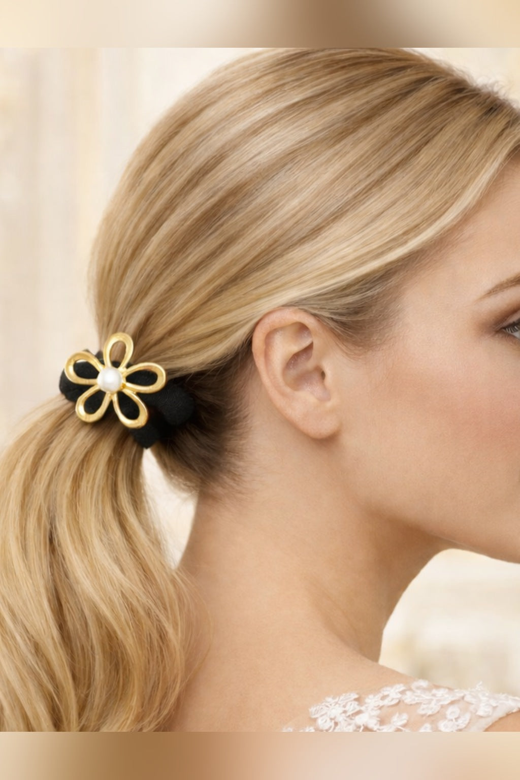 Pearl daisy hair tie worn on a low ponytail