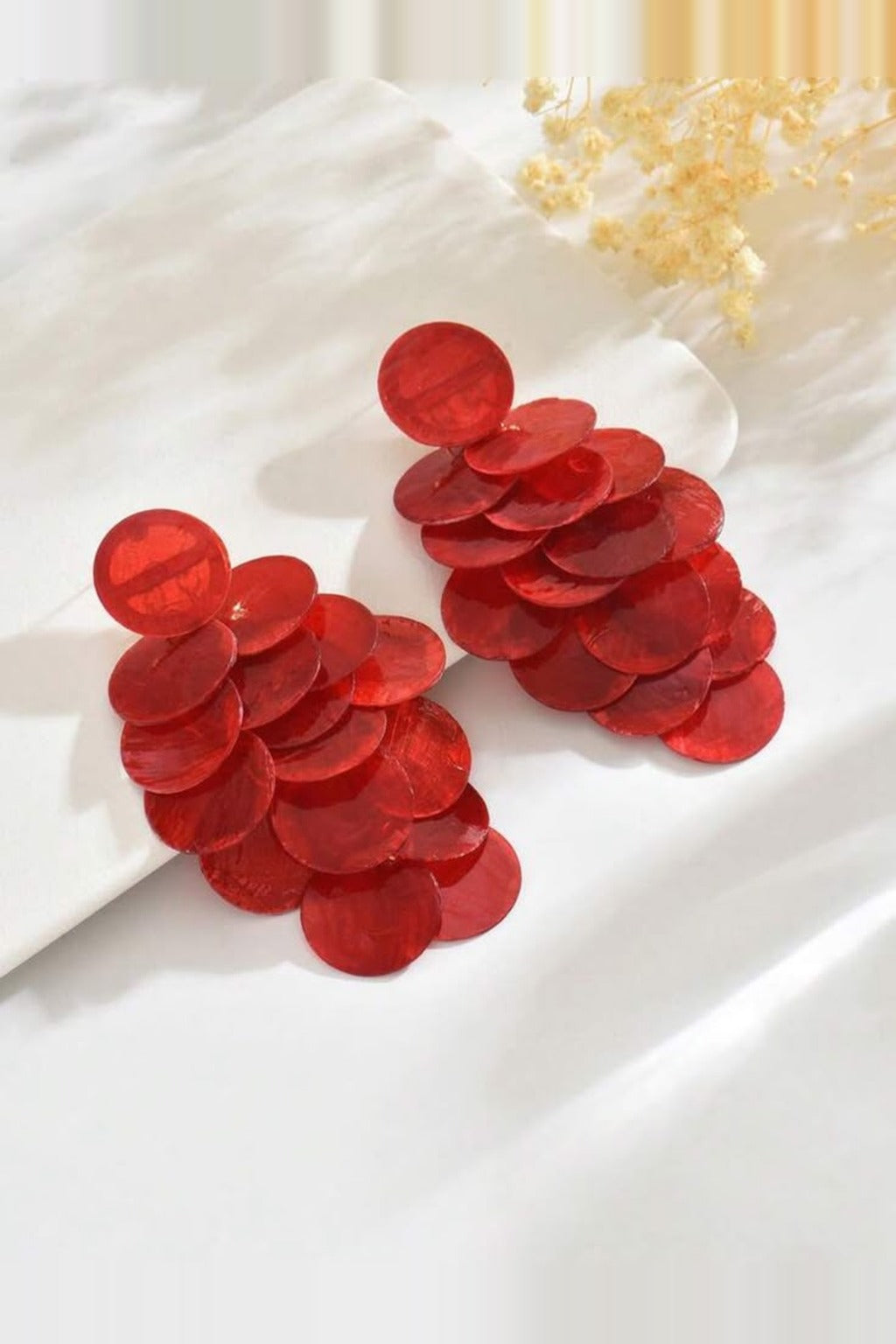 Red Shell Cascade Earrings – red capiz shell disc earrings on white satin