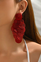 Red Shell Cascade Earrings worn on the ear – red shell disc cascade drop