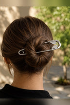 Big safety pin hair clip in a messy bun