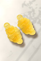 Yellow Shell Cascade Earrings – yellow capiz shell disc drop earrings on white marble in warm golden-hour sunlight